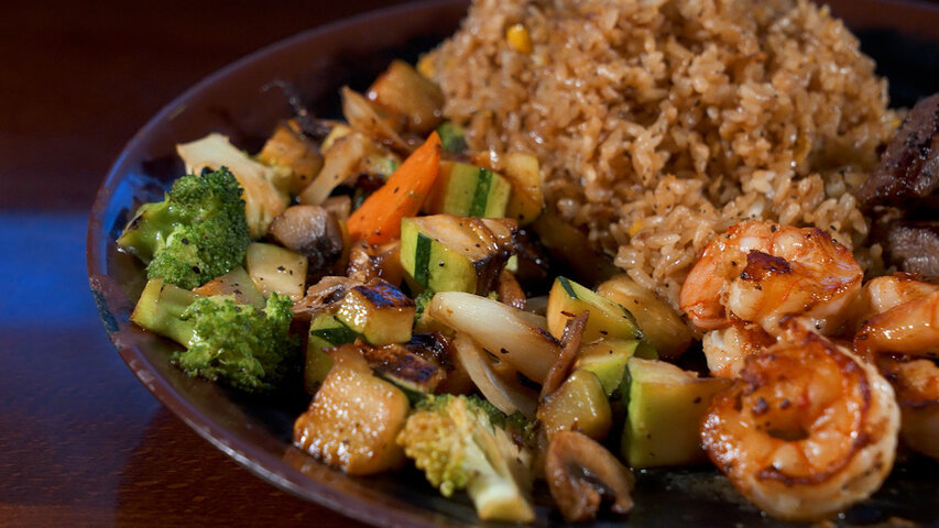 Professional hibachi chef preparing steak and shrimp in New England