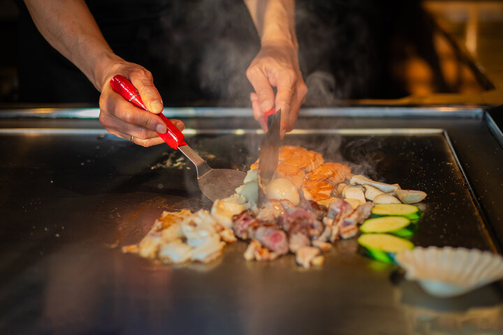Hibachi chef performing cooking show at New England party